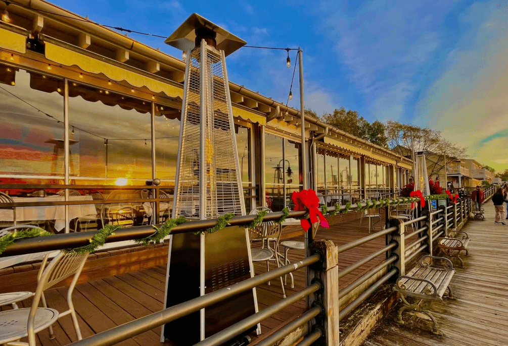 Exterior view of The George Restaurant on the Wilmington Riverwalk, featuring waterfront dining patios and scenic views of the Cape Fear River.
