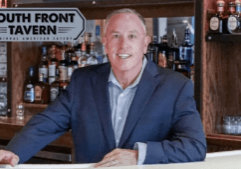 Owner Mark Zecher welcoming guests at South Front Tavern anniversary celebration in Wilmington NC
